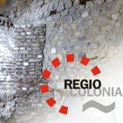 Alte gemauerte Wand mit dem Logo von Regio Colonia im Vordergrund
