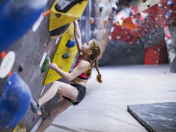 Little girl climbing on rock-climbing wall Little girl climbing on rock-climbing wall