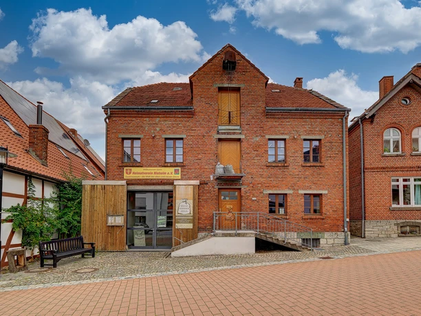 Sackmuseum Backsteingebäude des Sackmuseums mit Rampe, umgeben von gepflasterter Straße und Nachbarhäusern.
