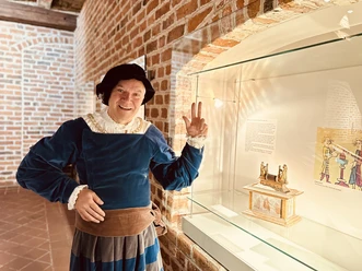 Andreas Rönnaus als Bürgermeister Witzendorff beim Bürgerschwur_©Lüneburg Marketing GmbH.jpg Bürgermeister Witzendorff mit erhobener Schwurhand an einer Vitrine. Historische Rathausführung.
