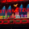 Stunksitzung Eine lebendig dekorierte Bühne mit kostümierten Künstlern, die Teil der Kölner Stunksitzung sind.A lively decorated stage with costumed artists who are part of the Cologne Stunksitzung.