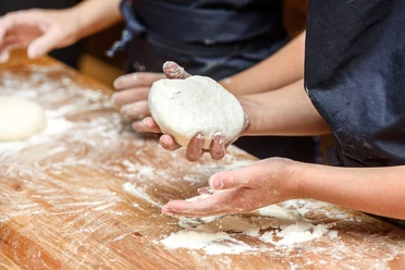 Close-up of children's hands preparing dough for pizza. Pizza, children and the concept of cooking - children make pizza. Close-up of children's hands preparing dough for pizza. Pizza, children and the concept of cooking - children make pizza.