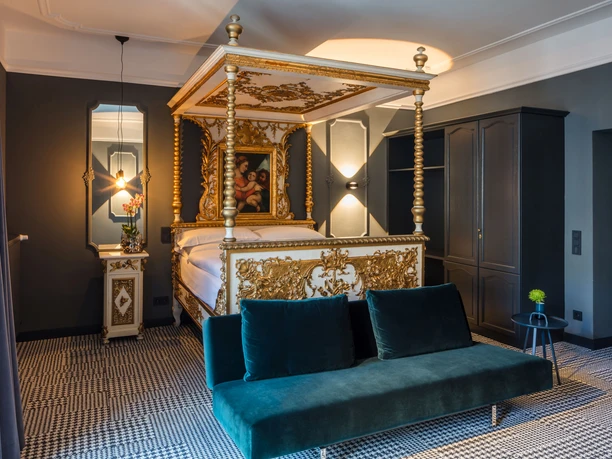 room view Hotel room with elegant four-poster bed and sofa