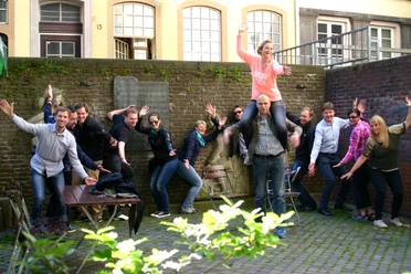 Auf geht's- Team Kön Menschen posieren für ein Gruppenfoto