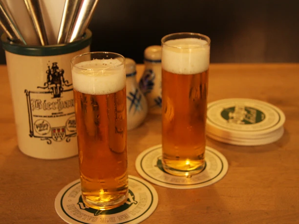 Brauhaus two full Kölsch glasses on the table