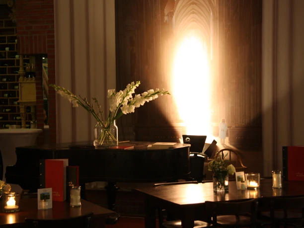 Kölner DinnerTour Dinner tables with piano in the background