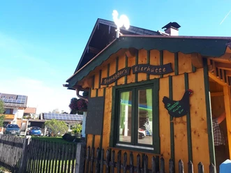 Boaneggers Freilandeier Farchant braunes Holzhütterl mit Fenster und der Aufschrift Boanegger`s Eierhütte