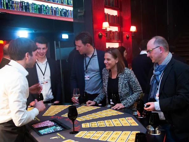 Hopfen & Malz. Bier Black-Jack People at the blackjack table in elegant surroundings with red lighting, playing and chatting.</p> <p