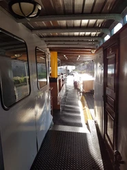 ©Dorothee Meyer (8).jpg Sunlit walkway along a historic paddle steamer’s covered deck with metal flooring.