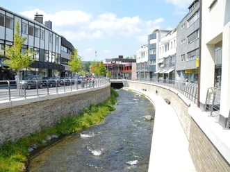 HenneBoulevard in Meschede mit Henne, Uferwegen, Geländern und Innenstadtbebauung