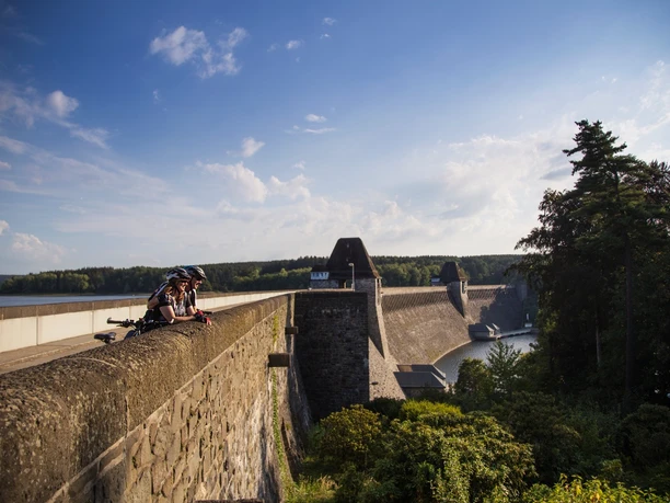 Radfahrer Staumauer Möhnesee Radfahrer pausieren auf der Staumauer am Möhnesee mit weitem Blick über Wald und Wasser