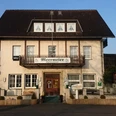 Hotel-Restaurant Meermeier Ein dreistöckiges Gebäude mit traditionellem Fachwerkdesign und dem Schild "Meermeier Restaurant".
