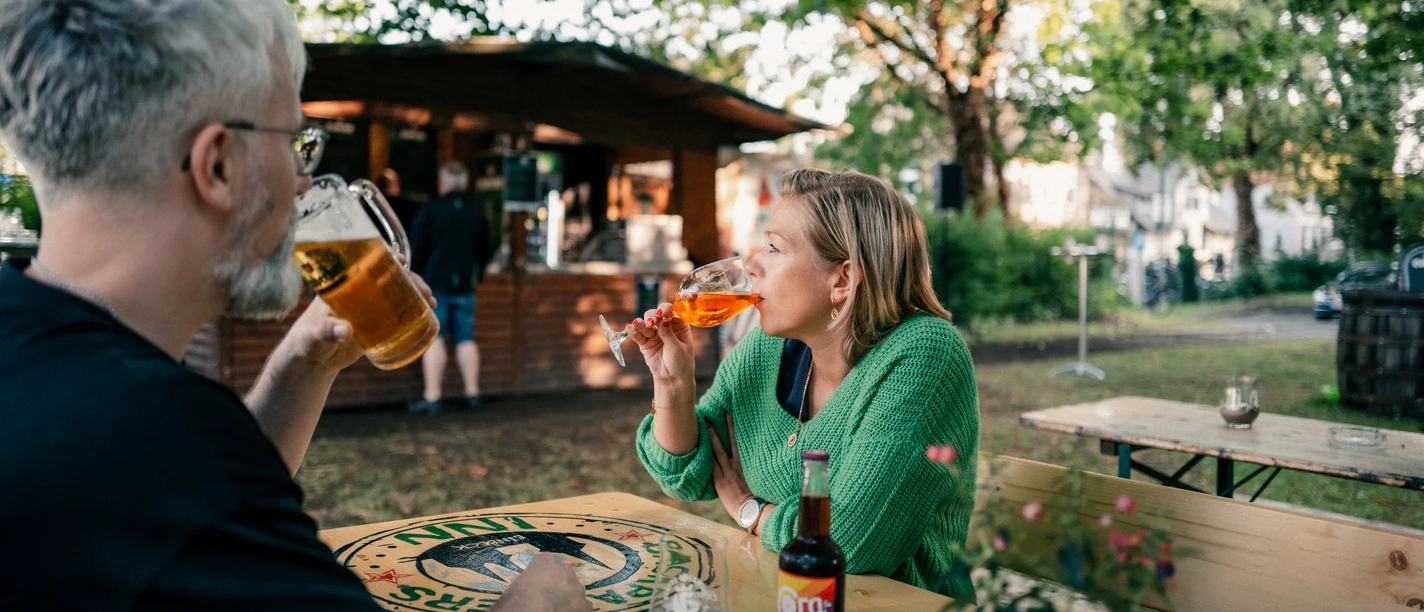 Biergarten Zwei Personen sitzen zusammen im Einbecker Biergarten und trinken Kaltgetränke.