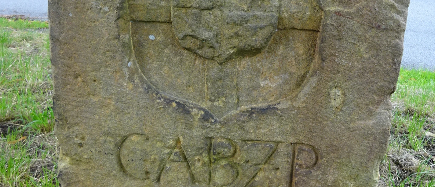Grenzstein_Paderborn_Rietberg1_CC-BY-SA_Teutoburger_UllaLehmann.JPG Alter Grenzstein aus Sandstein mit Fassadenschmuck, Inschrift "CABZP", Jahreszahl 1757, eingewachsenes Gras.