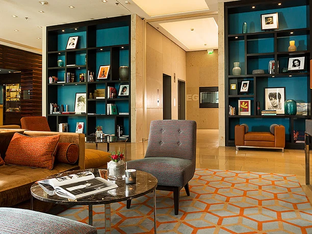 Lobby 1.jpg Cozy lobby in modern style with elegant furniture, colorful artwork and decorative shelves.