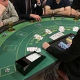Black Jack 01 Poker-Spieler an rundem grünen Tisch mit Karten, Getränken und Chips in geselliger Atmosphäre.Poker players at a round green table with cards, drinks and chips in a convivial atmosphere.