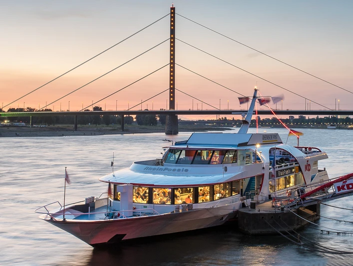 MS_RheinPoesie Passenger ship "RheinPoesie" in front of the Rheinkniebrücke bridge at sunset on the Rhine.</p> <p