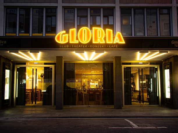 GLORIA Exterior view of the illuminated Gloria Theater with eye-catching golden neon lettering.</p> <p