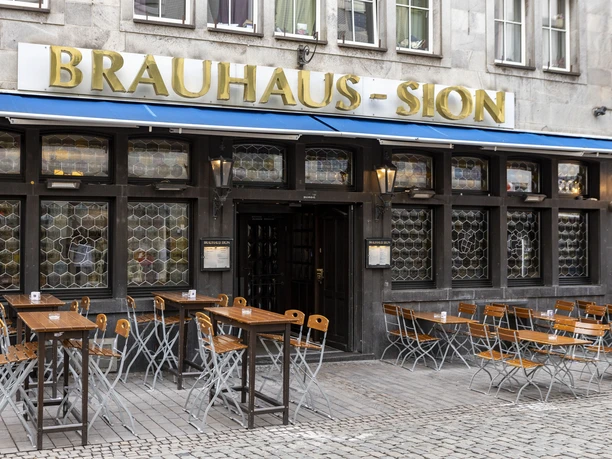 Brewery Sion Outdoor dining in front of the Brauhaus . The words Brauhaus Sion are written on the façade in gold letters.