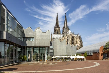 Museum Ludwig with Cologne Cathedral in the background, under a clear sky.