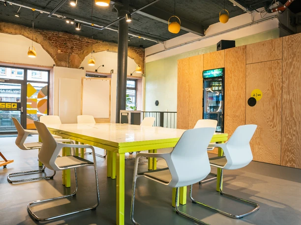 Panorama1.jpg Modern meeting room with brick wall, block seating, TV and kitchen area