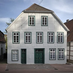 Poelmahn Haus Das Poelmahn Haus in Vlotho vereint traditionelles Fachwerkdesign mit weißen und grünen Elementen.
