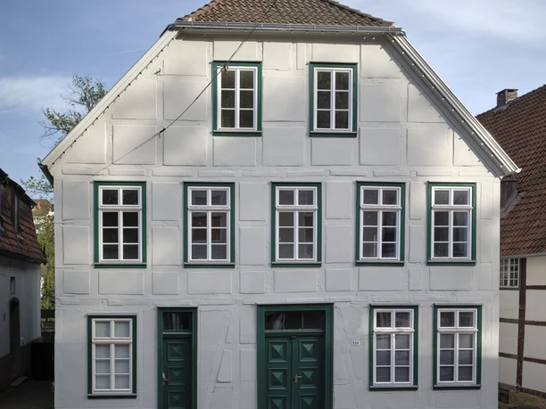 Poelmahn Haus Das Poelmahn Haus in Vlotho vereint traditionelles Fachwerkdesign mit weißen und grünen Elementen.