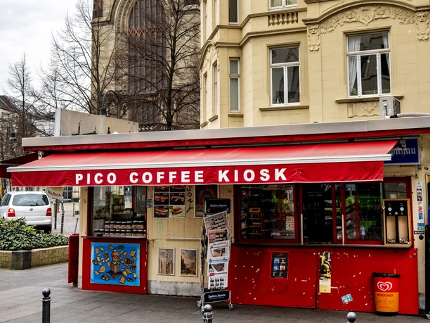 Pico Coffee The picture shows the majestic tower of the Agneskirche in Cologne, behind the Kiosk Café in the Agnesviertel.