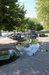 Paolozzi Fountain The Paolozzi fountain features artistic stone and water elements in the shady city park.