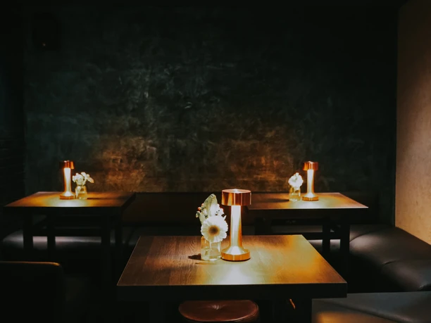 GG_Nov_23_4.jpg Wooden tables and leather sofa in dim lighting