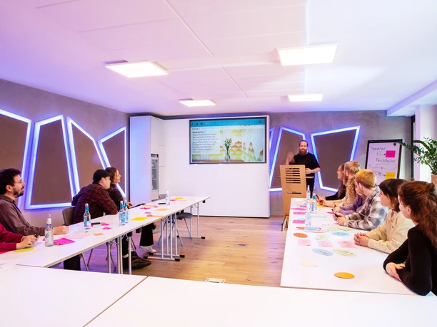 The Pattern Beuys 1.jpg Stylish conference room with people sitting in a U-shape