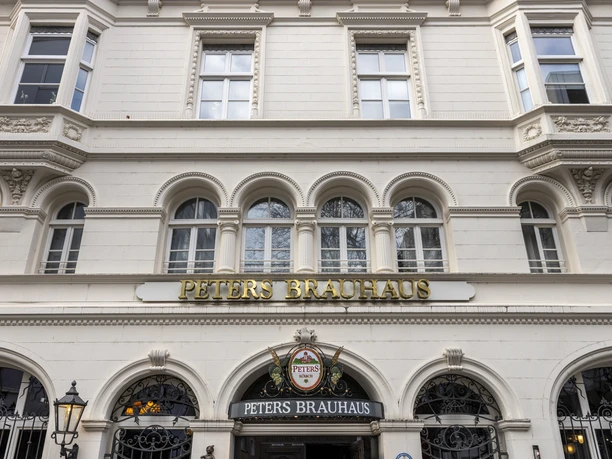Peters Brauhaus Peters Brauhaus with its historic white facades and golden lettering in Cologne.