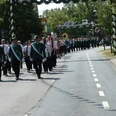 Festumzug.JPG Festumzug beim Schützenfest in Bispingen: Menschen in grünen Uniformen auf der Straße.
