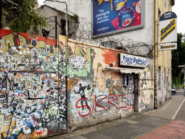 Sonic Ballroom The façade of the Sonic Ballroom features graffiti and posters surrounded by barbed wire.