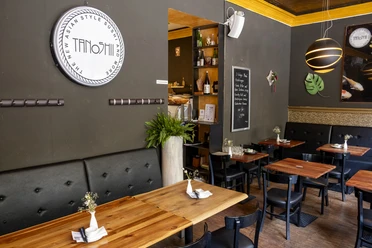 Tanoshii Innenansicht des Restaurants Tanoshii: Moderne, gemütliche Atmosphäre mit Holz- und Schwarzakzenten.