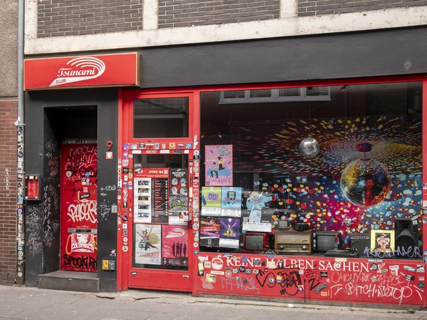 Tsunami Club The façade of the Tsunami Club in urban style, littered with street art and posters.