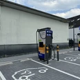 Ladesäule Engelskirchen Zwei Elektroladestationen für Autos auf einem Parkplatz, mit geparkten Elektrofahrzeugen und Beschilderung.