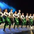 Danceperados Tänzer in traditioneller irischer Kleidung führen eine synchrone Stepptanz-Performance auf der Bühne auf.