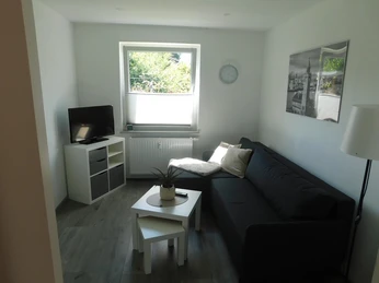 Wohnzimmer der Ferienwohnung Hoops Wohnzimmer der Ferienwohnung HoopsLiving room of the Hoops vacation apartmentOpholdsstuen i ferielejligheden HoopsWoonkamer van de vakantiewoning Hoops