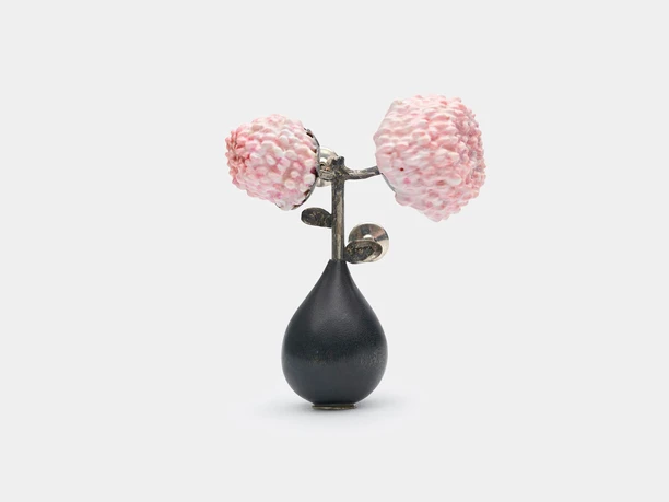 Saerom Kong, brooch "Cherry Blossom II" A handmade metal brooch features delicate pink cherry blossoms on a dark gray background.