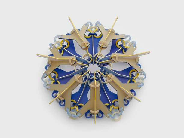Svenja John, brooch "NOKOMIS" Colorful brooch made of geometric elements arranged in a star shape on a grey background.