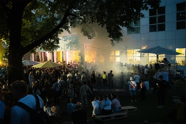 EL BARRIO Crowd at open-air event in front of building