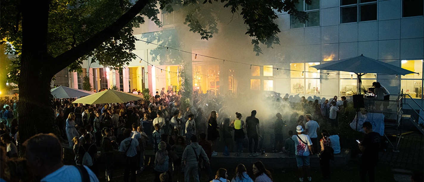 EL BARRIO Crowd at open-air event in front of building