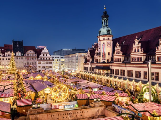 View of the brightly lit Christmas market on the market square in Leipzig in the evening