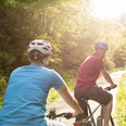 Biker-Paar beim Genussradeln im Sonnenschein Biker-Paar beim Genussradeln im Sonnenschein