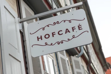 Hofcafé Schild Nahaufnahme eines Schilds mit Aufschrift "Hofcafé" an einem Fachwerkhaus