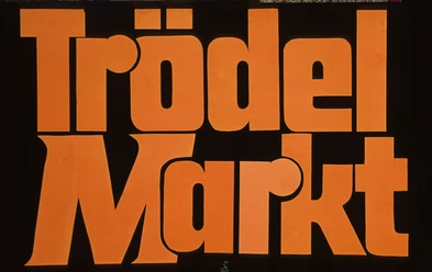 Große, orangefarbene Schrift auf schwarzem Hintergrund mit dem Text "Trödel Markt".