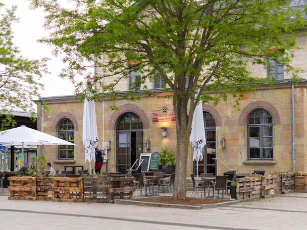 Outdoor seating area in front of the "Wok In" restaurant