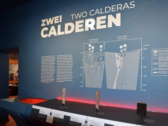 4 - Supervulkan-Zentrum R├Âcknitz - Dauerausstellung - Foto Sara H├Âhne.jpg Ausstellungstafel im Supervulkan-Zentrum zeigt die Struktur von zwei Calderas.Exhibition board in the Supervolcano Center shows the structure of two calderas.Výstavní tabule v supervulkánovém centru ukazuje strukturu dvou kalder.Tablica wystawowa w Centrum Superwulkanów pokazuje strukturę dwóch kalder.Tentoonstellingsbord in het Supervulkaancentrum toont de structuur van twee caldera's.Il pannello espositivo del Centro Supervulcano mostra la struttura di due caldere.
