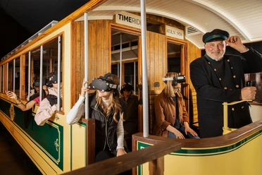 Timeride SENSEUM People in a historic streetcar wear VR glasses and experience a virtual journey through time.